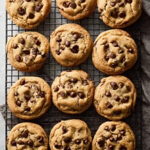 Freshly baked chewy chocolate chip cookies cooling on a wire rack