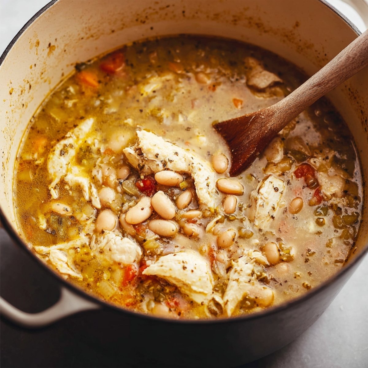 A bowl of freshly shredded chicken, ready to be added to a recipe, with a clean and tender texture.