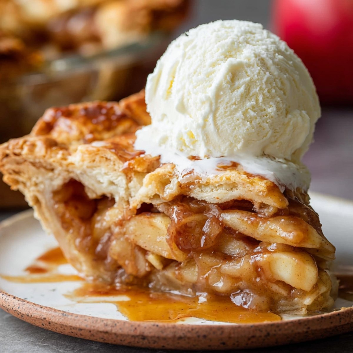 Apple Pie Recipe A delicious slice of apple pie with a golden flaky crust, served with a scoop of vanilla ice cream on top, melting into the warm pie, ready to be enjoyed.