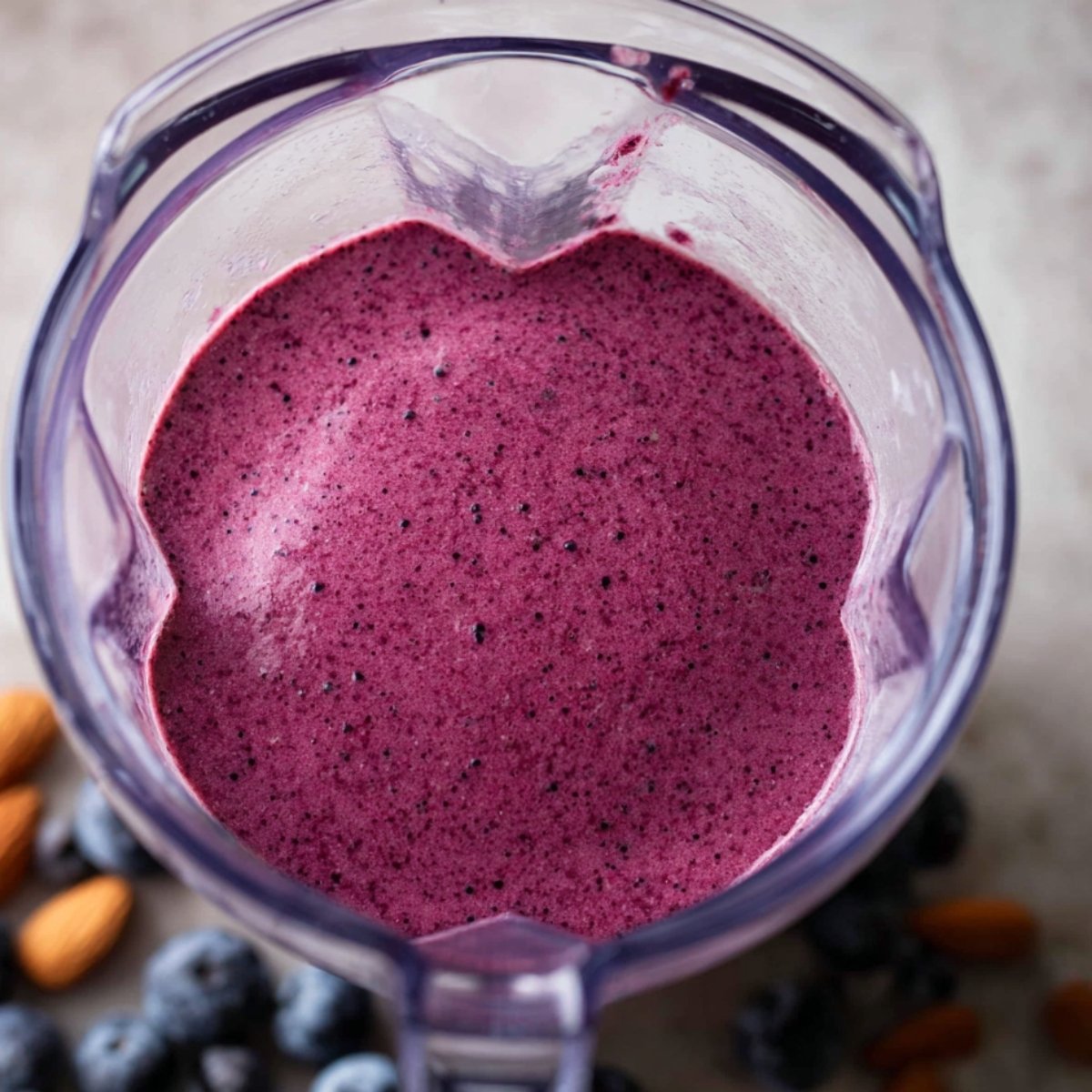 "Whip up a delicious and nourishing blueberry-banana smoothie that blends antioxidant-packed blueberries with the creamy richness of bananas. A dash of lemon adds a refreshing burst of flavor. The smoothie should be smooth and thick, served in tall glasses with fresh blueberries and a slice of lemon on top. This vibrant drink is ideal for a morning energy boost or as a wholesome snack!