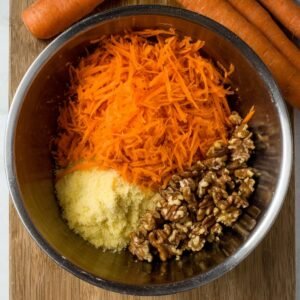 "The base of a delicious carrot cake, with eggs and wet ingredients ready to be mixed into the batter."