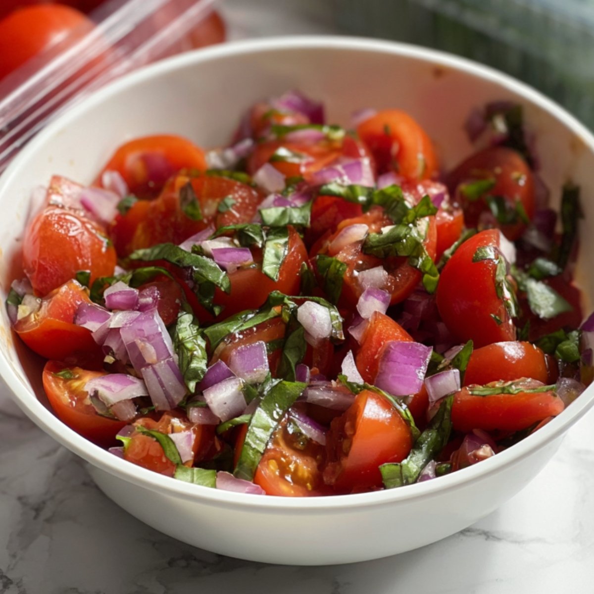 A white bowl filled with raw chicken strips coated in a brown seasoning or marinade, ready to be cooked.
